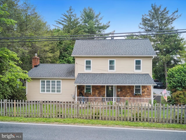 1501 Long Corner Rd, Mount Airy, MD 21771 - view of front of property with covered porch, a chimney, a fenced front yard, stone siding, and a shingled roof