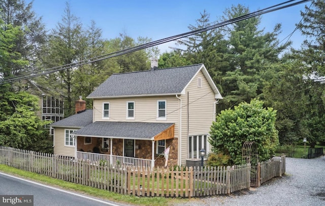 1501 Long Corner Rd, Mount Airy, MD 21771 - view of front facade with covered porch, a fenced front yard, a chimney, and a shingled roof