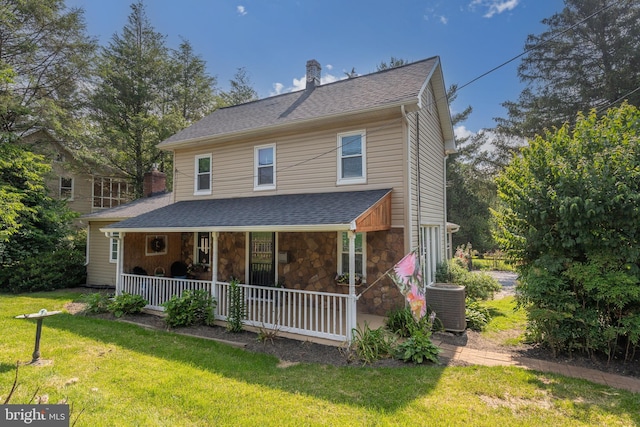 1501 Long Corner Rd, Mount Airy, MD 21771 - view of front of house featuring covered porch, central AC unit, a front yard, a chimney, and stone siding