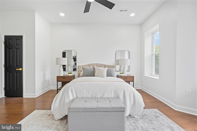 bedroom featuring baseboards, recessed lighting, and wood finished floors