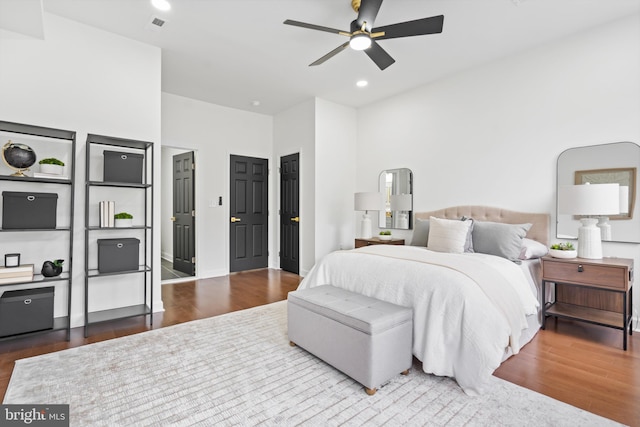 bedroom with ceiling fan, dark wood finished floors, recessed lighting, and visible vents
