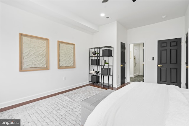 bedroom with connected bathroom, a ceiling fan, visible vents, baseboards, and dark wood-style floors