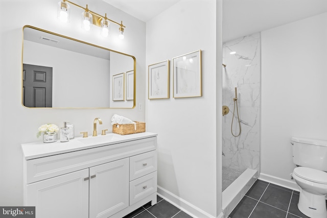 full bathroom featuring toilet, baseboards, tile patterned flooring, vanity, and a marble finish shower