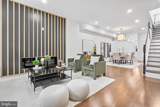 living area featuring stairway, recessed lighting, and wood finished floors