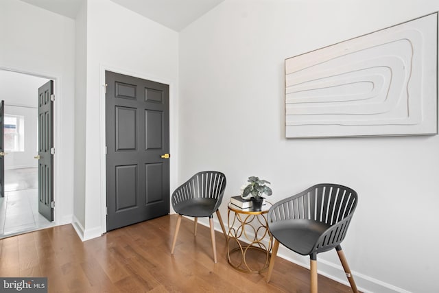living area with wood finished floors and baseboards