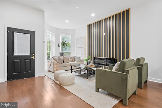 living room with baseboards, recessed lighting, and wood finished floors
