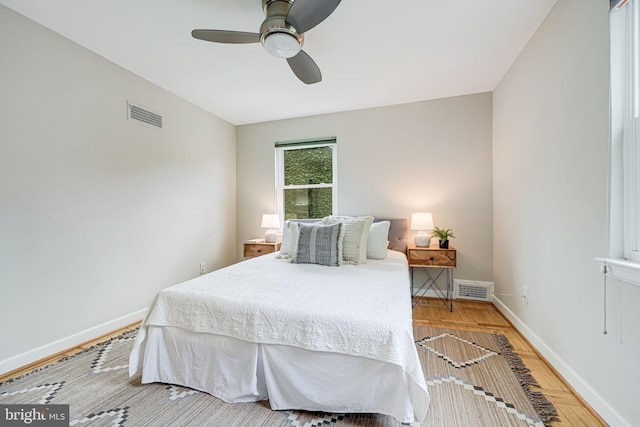 bedroom featuring wood finished floors, baseboards, and a ceiling fan