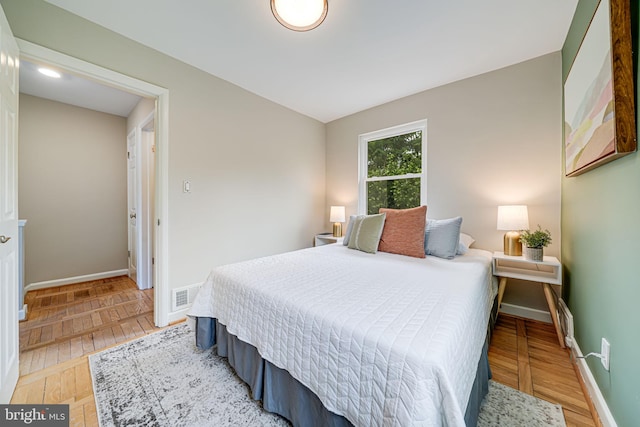 bedroom featuring light wood-type flooring and baseboards