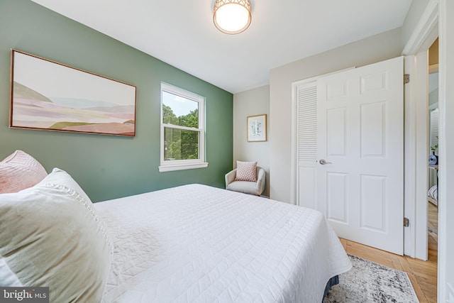 bedroom with a closet and wood finished floors
