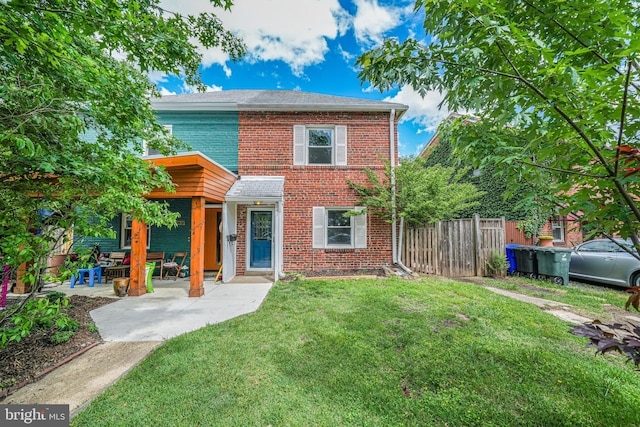 view of front of property with brick siding and a patio