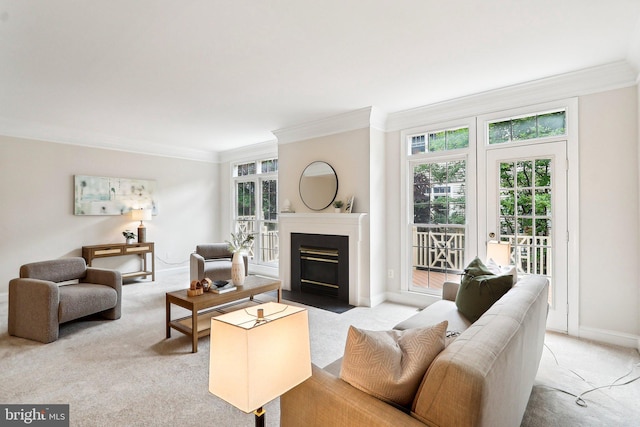 carpeted living area with ornamental molding, healthy amount of natural light, a fireplace with flush hearth, baseboards, and french doors