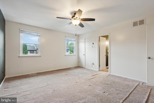 unfurnished bedroom with carpet floors, baseboards, and a ceiling fan
