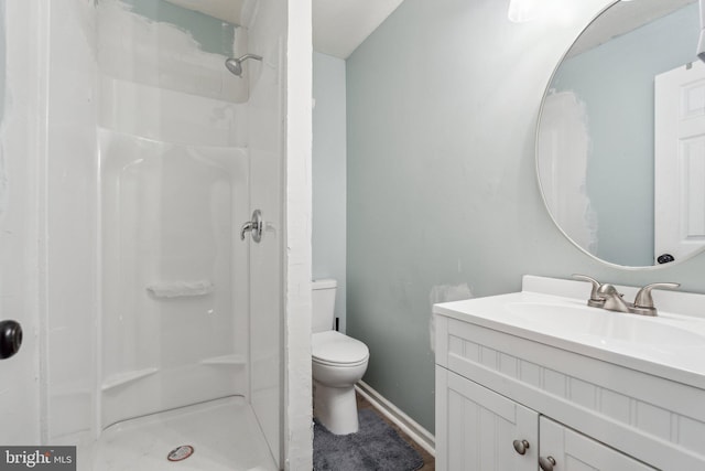 27076 Jennings Dr, Ruther Glen, VA 22546 - bathroom featuring toilet, a stall shower, vanity, and baseboards