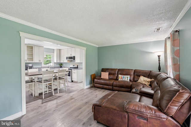 27076 Jennings Dr, Ruther Glen, VA 22546 - living area featuring ornamental molding, light wood finished floors, a textured ceiling, and baseboards