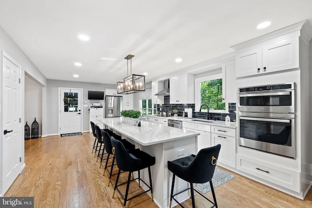 15807 Marlington Dr, Dumfries, VA 22025 - kitchen featuring light wood finished floors, white cabinetry, stainless steel appliances, and a sink