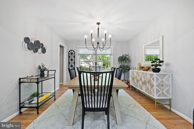 15807 Marlington Dr, Dumfries, VA 22025 - dining room with baseboards, a notable chandelier, and wood finished floors