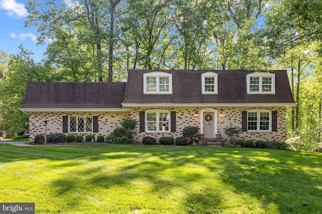 15807 Marlington Dr, Dumfries, VA 22025 - cape cod-style house featuring roof with shingles, mansard roof, brick siding, and a front yard