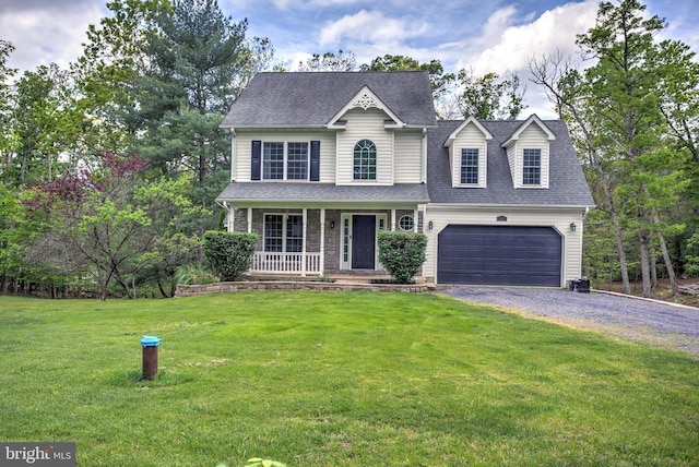 traditional home featuring driveway, roof with shingles, covered porch, and a front yard