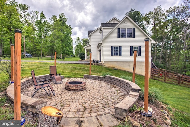 view of patio / terrace featuring a fire pit and fence