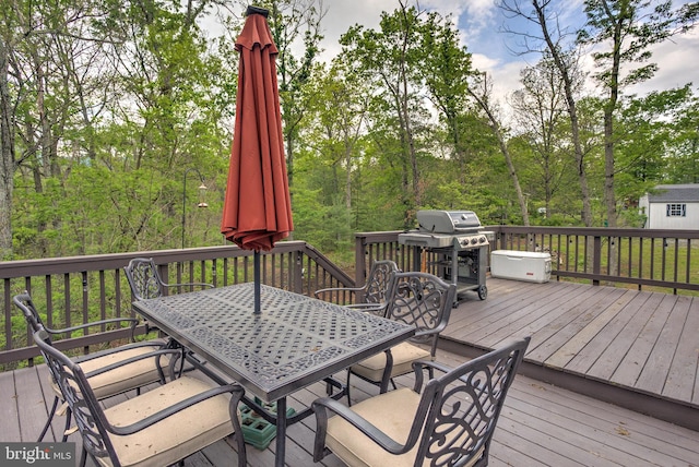 deck featuring area for grilling and outdoor dining area