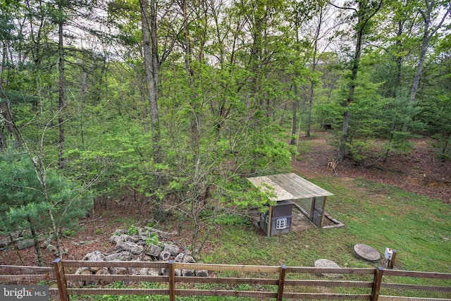 view of yard with a view of trees and fence