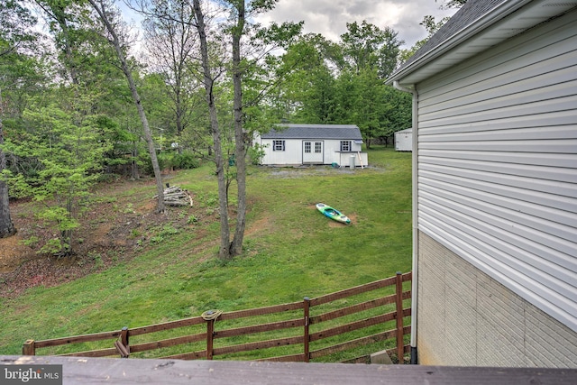 view of yard featuring fence and an outdoor structure