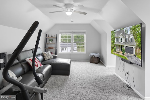 interior space featuring vaulted ceiling, carpet flooring, baseboards, and a ceiling fan
