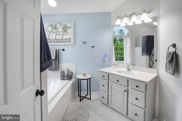 full bath with tile patterned floors, baseboards, vanity, and a garden tub
