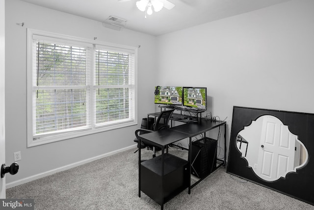 office space featuring baseboards, carpet floors, a ceiling fan, and visible vents