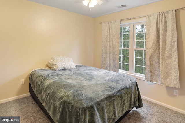 carpeted bedroom featuring baseboards and visible vents