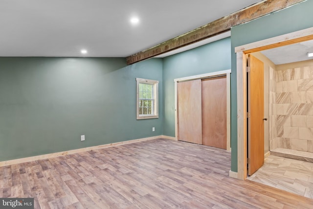 unfurnished bedroom with wood finished floors, recessed lighting, a closet, and baseboards