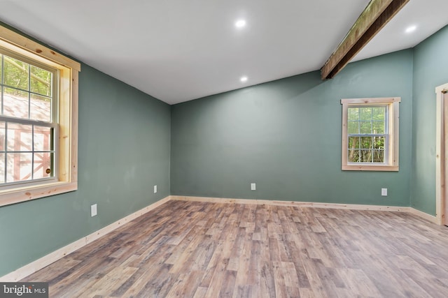 unfurnished room featuring wood finished floors, baseboards, recessed lighting, and vaulted ceiling