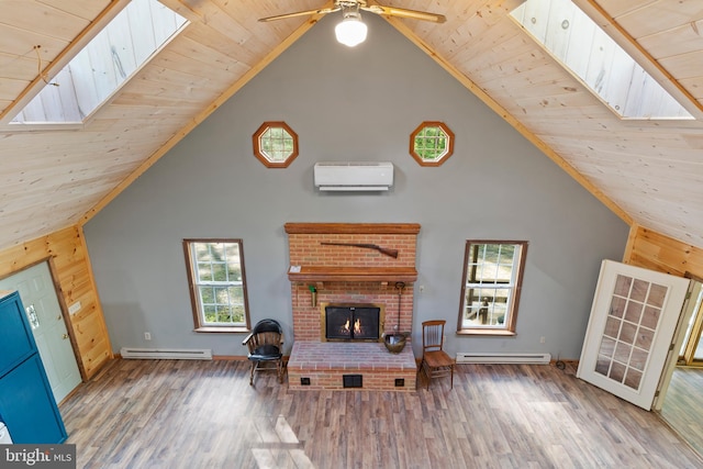 living room with high vaulted ceiling, a wall mounted air conditioner, a fireplace, wood finished floors, and a baseboard heating unit
