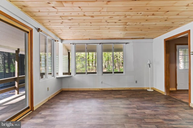 empty room with wooden ceiling, wood finished floors, and baseboards