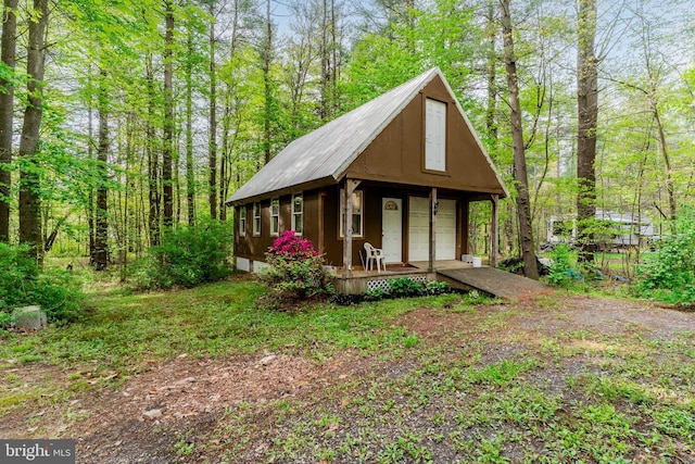 view of outbuilding featuring an outbuilding and a forest view