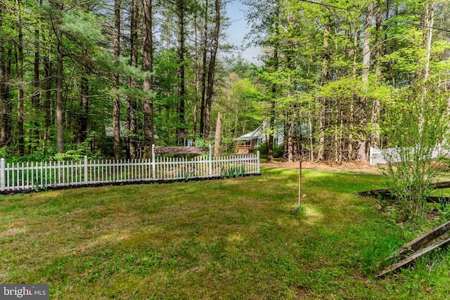 view of yard with a forest view