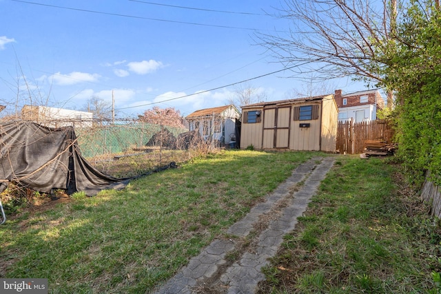 view of yard featuring a storage unit and an outbuilding