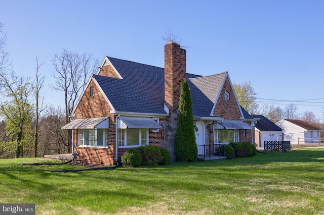 10 E Canal Rd, York, PA 17404 - view of front of house with a chimney, brick siding, and a front lawn