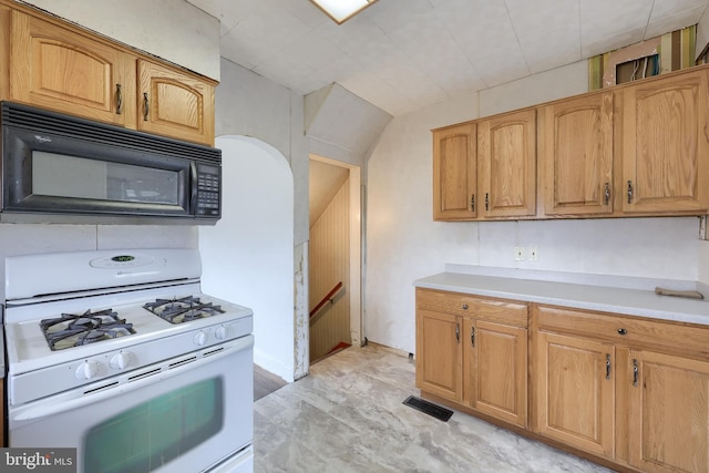 10 E Canal Rd, York, PA 17404 - kitchen with black microwave, light countertops, visible vents, and white gas range oven