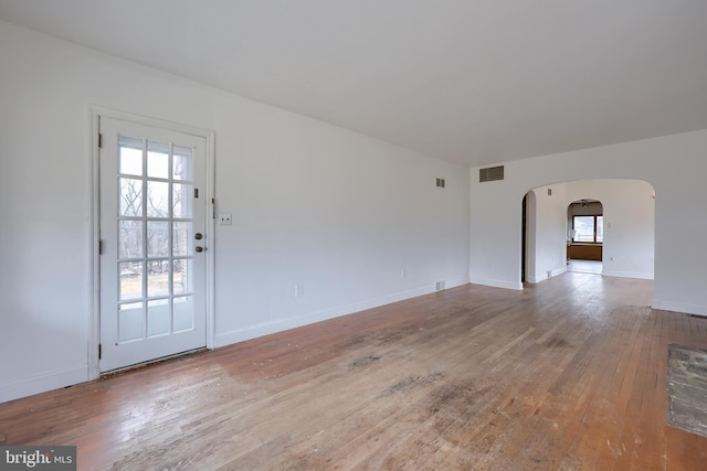 10 E Canal Rd, York, PA 17404 - spare room featuring arched walkways, baseboards, visible vents, and wood-type flooring