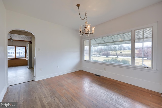 10 E Canal Rd, York, PA 17404 - unfurnished dining area featuring hardwood / wood-style floors, visible vents, a chandelier, arched walkways, and plenty of natural light
