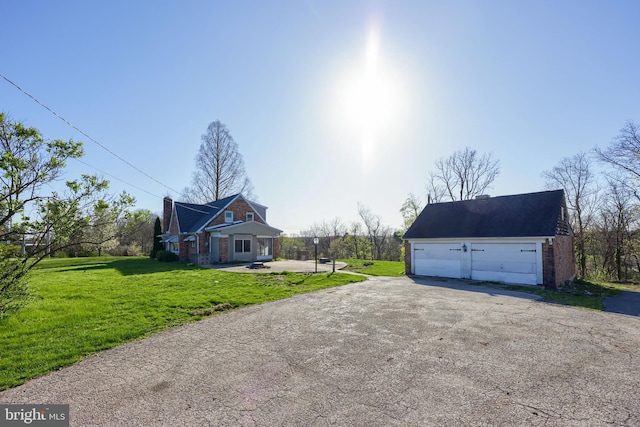 10 E Canal Rd, York, PA 17404 - view of side of property with a yard, a detached garage, an outbuilding, and brick siding