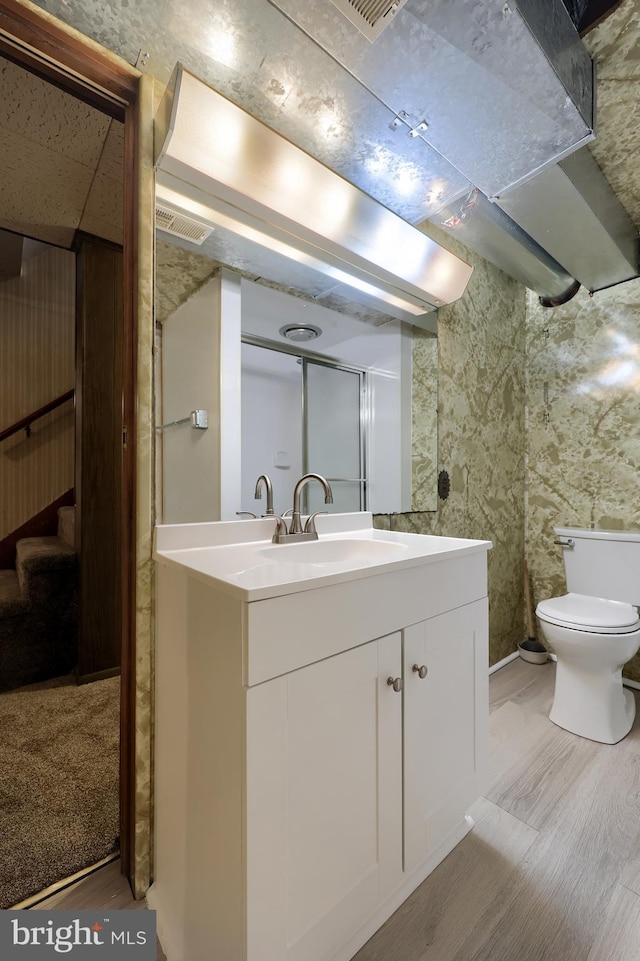 10 E Canal Rd, York, PA 17404 - bathroom with toilet, wood finished floors, and vanity