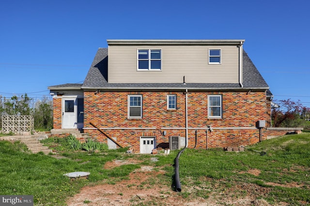 10 E Canal Rd, York, PA 17404 - rear view of house with central air condition unit, roof with shingles, brick siding, and a yard