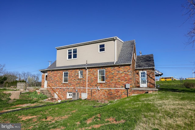 10 E Canal Rd, York, PA 17404 - rear view of property featuring a yard, roof with shingles, and brick siding