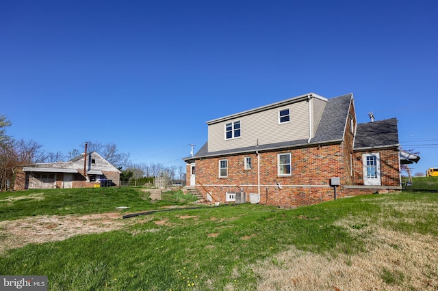 10 E Canal Rd, York, PA 17404 - rear view of house with a yard, brick siding, and a shingled roof