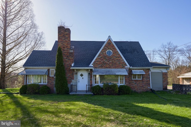 10 E Canal Rd, York, PA 17404 - english style home featuring brick siding, a shingled roof, a chimney, and a front yard