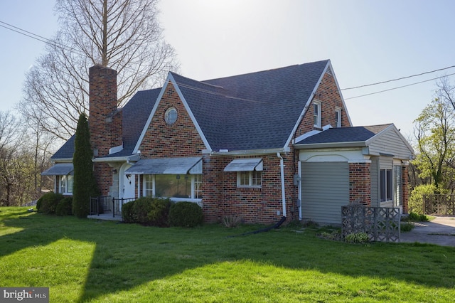 10 E Canal Rd, York, PA 17404 - exterior space featuring a front lawn, brick siding, roof with shingles, and a chimney