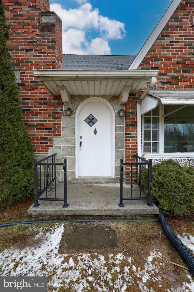 10 E Canal Rd, York, PA 17404 - property entrance featuring brick siding, roof with shingles, and a chimney