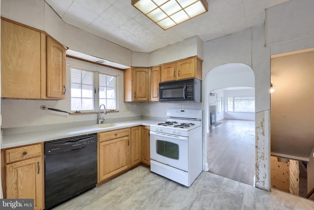 10 E Canal Rd, York, PA 17404 - kitchen featuring arched walkways, black appliances, a sink, and a wealth of natural light